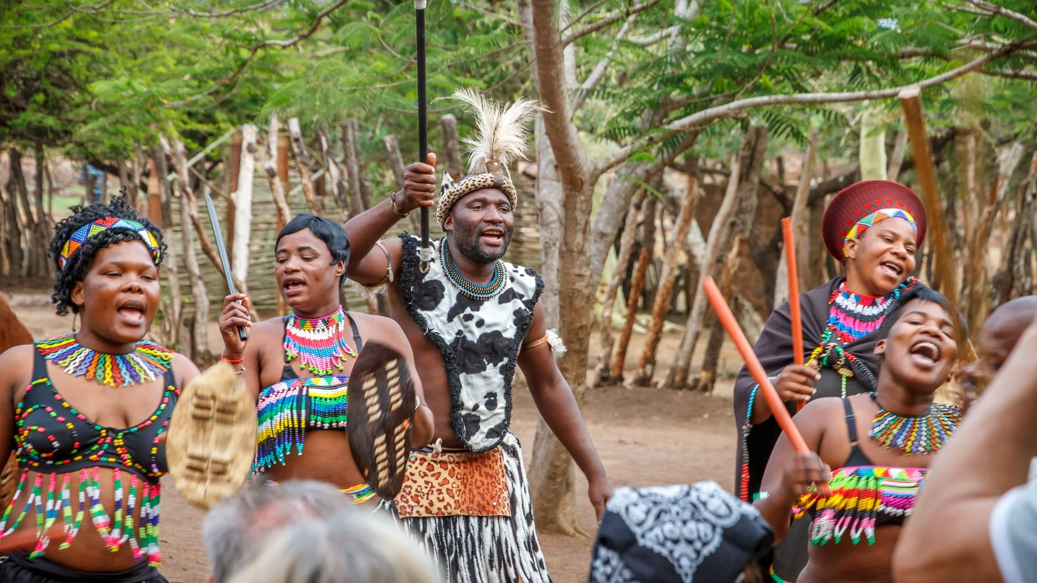 Chief Zondi leading amabutho and women in traditional dress in celebratory song and dance